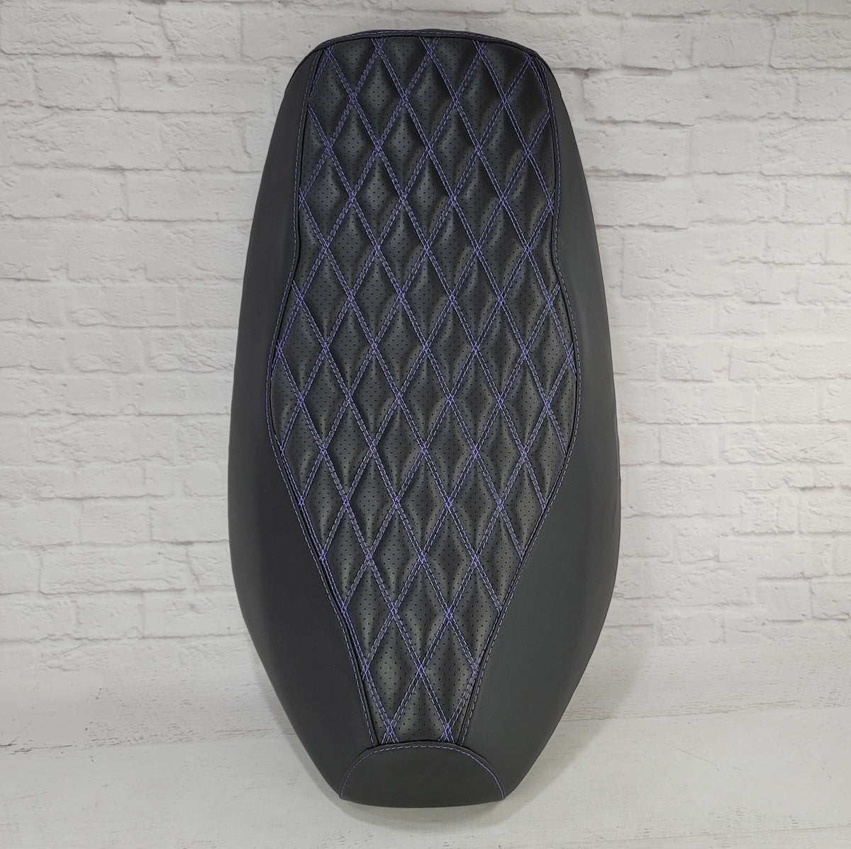 Top view of the Yamaha Zuma 50 Double Diamond seat cover showing the full purple-stitched quilted panel, handmade by Cheeky Seats.