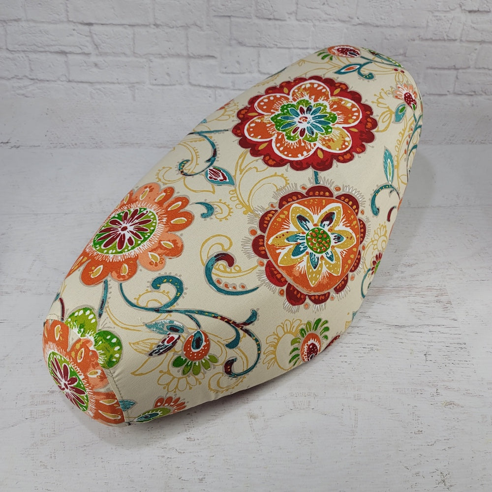 Ecru floral Cheeky Seats cover for a Genuine Buddy seat with orange, green and teal flowers