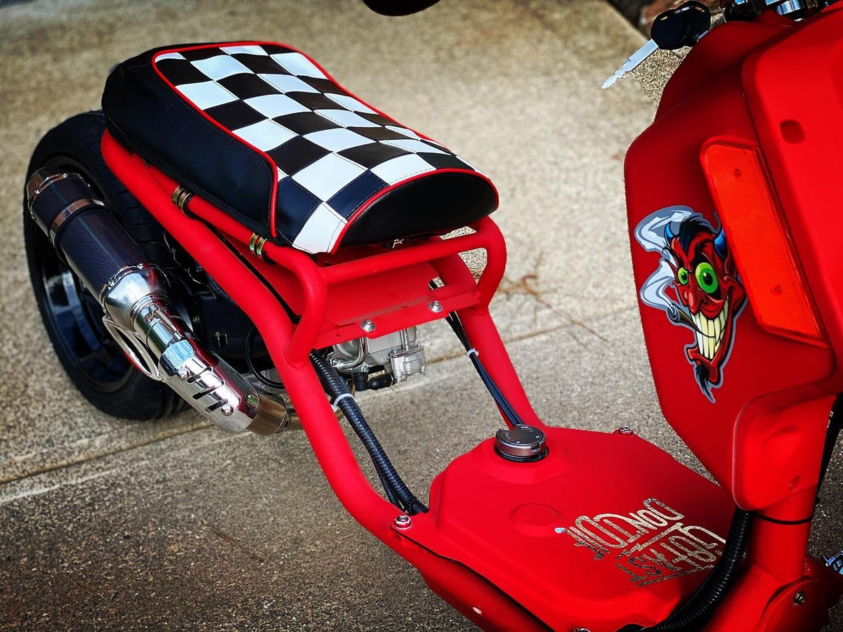Customer photo of a red Maddog scooter with custom graphics and the black and white checkerboard Cheeky Seats cover installed