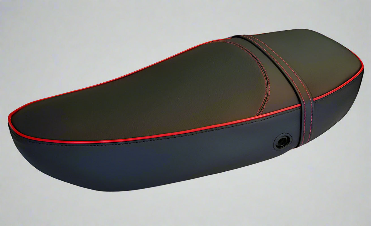 Matte black Vespa S and LX touring-saddle seat cover with red piping and matching strap, handmade by Cheeky Seats