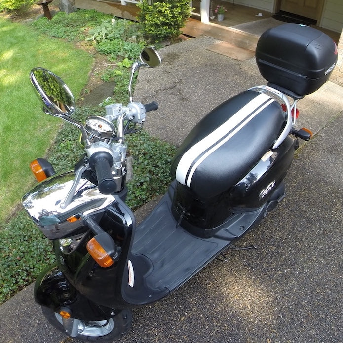 Dual Racing Stripes seat cover fitted to a black Yamaha Vino 125, creating a crisp vintage racing look, handmade by Cheeky Seats.