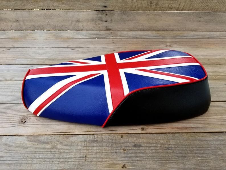 Side profile of a Union Jack Genuine Buddy Kick 125 seat cover showing black side panels and red piping, handmade by Cheeky Seats