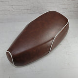 Distressed whiskey brown Genuine Buddy Kick 125 seat cover with white piping, handmade by Cheeky Seats