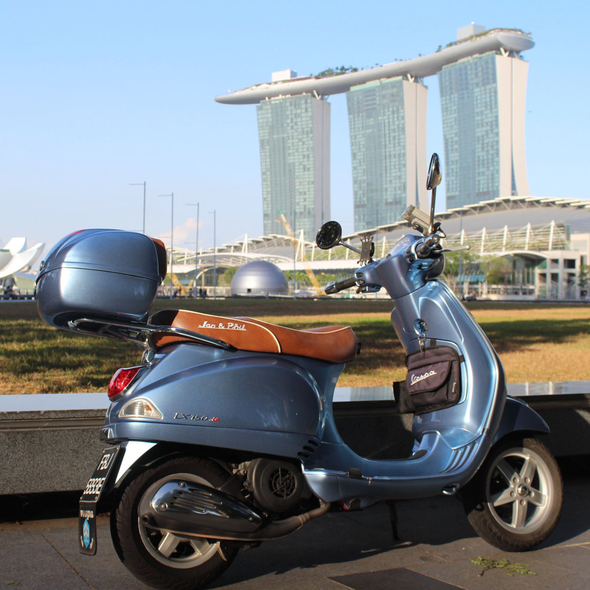 Vespa LX caramel seat cover installed on scooter