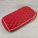 Red diamond-stitched Maddog seat cover with white piping, three-quarter view, handmade by Cheeky Seats