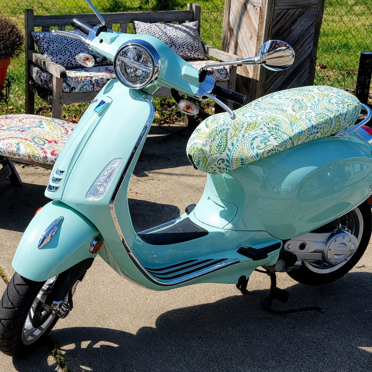 Green and Blue Paisley seat cover fitted to a mint Vespa Sprint or Primavera outdoors, handmade by Cheeky Seats.