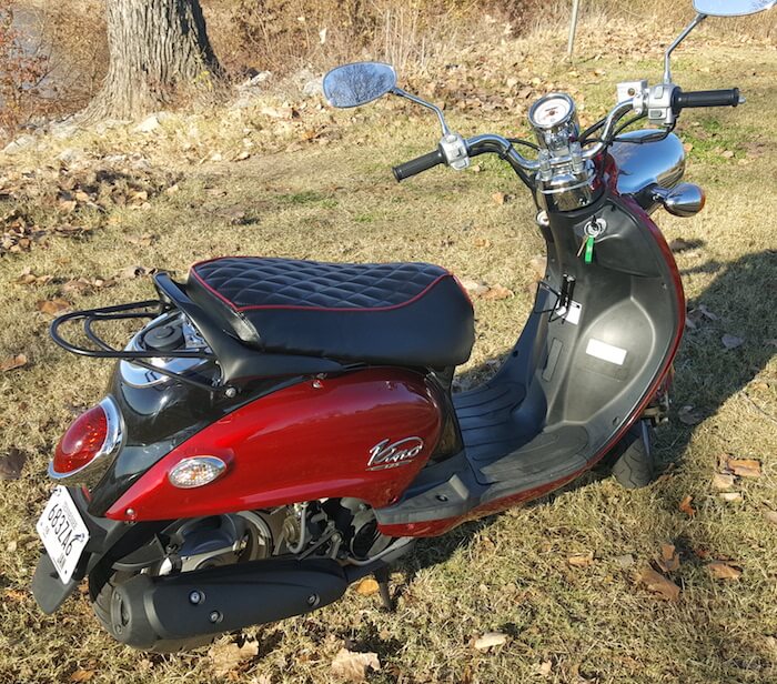 Diamond-quilted black seat cover fitted to a red Yamaha Vino 125, showing its tailored shape and contrasting red piping, handmade by Cheeky Seats.