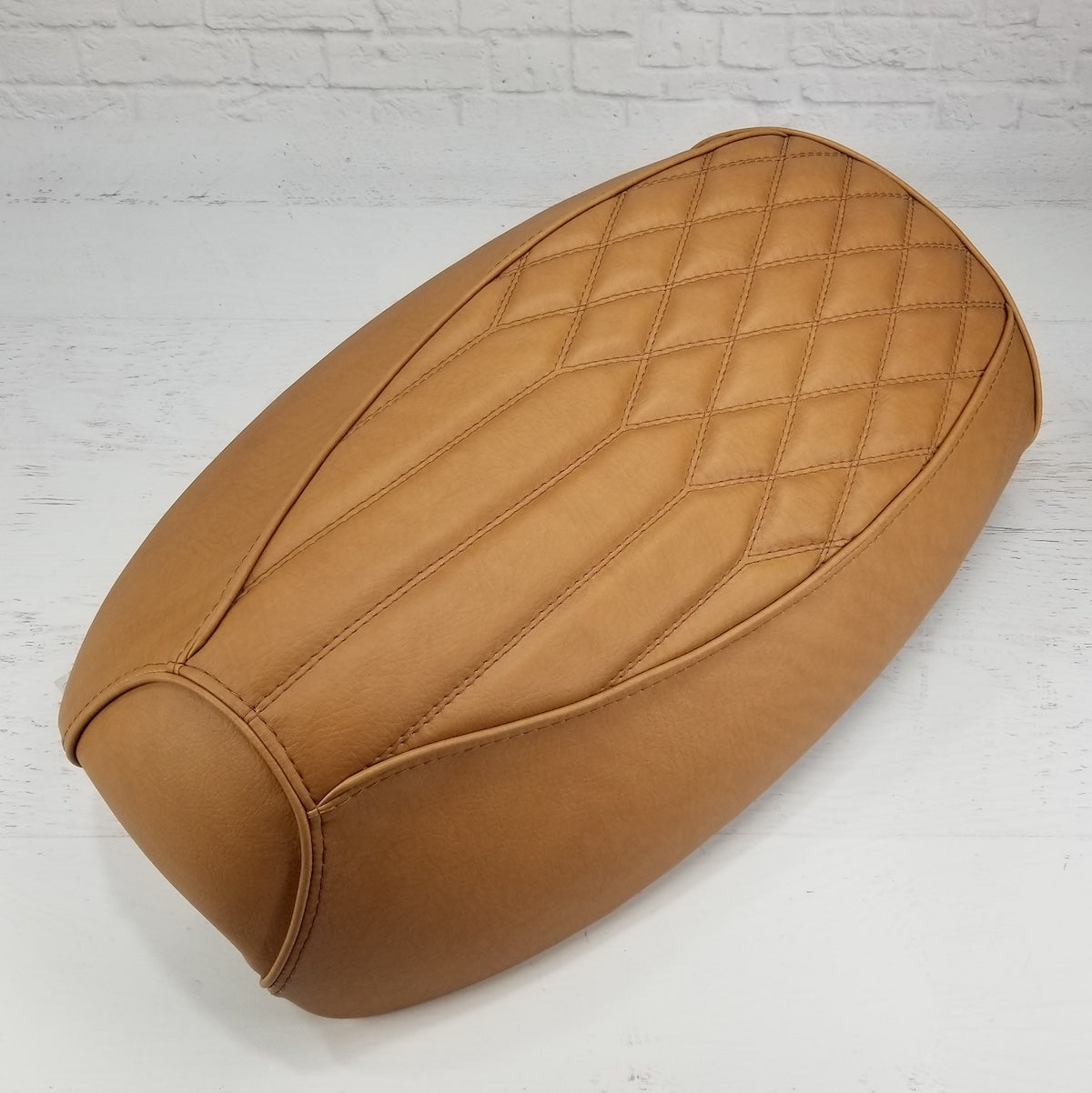 Golden Tan Yamaha Vino 125 seat cover combining center pleats with a diamond-quilted rear panel and matching piping, handmade by Cheeky Seats.