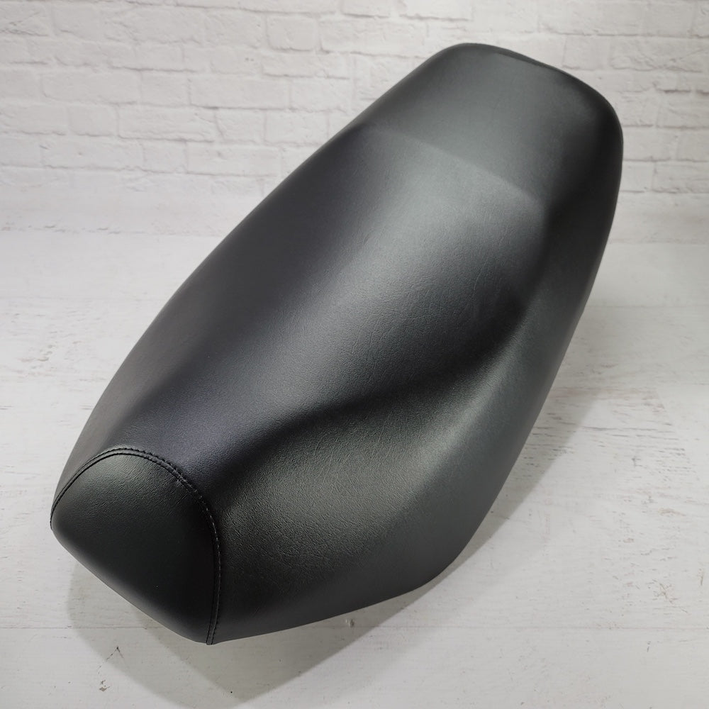 Ready-to-ship Classic Black seat cover tailored for the Yamaha Zuma 50, with a smooth factory-style finish, handmade by Cheeky Seats.