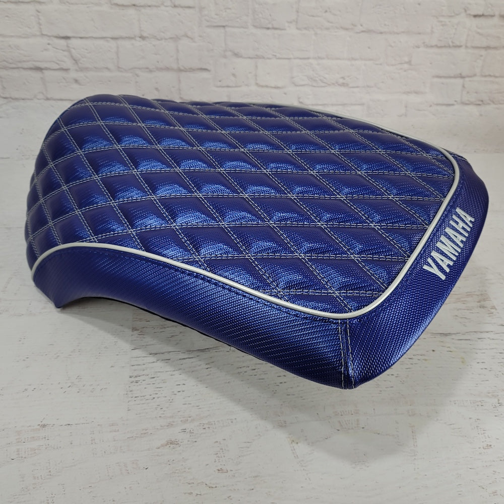 Side view of the Blue Carbon Yamaha C3 seat cover showing diamond quilting, silver piping and embroidered Yamaha lettering, handmade by Cheeky Seats.