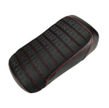 Black Bride fabric seat cover with repeating BRIDE text pattern, red contrast stitching, and padded tuck-and-roll pleats, handmade by Cheeky Seats